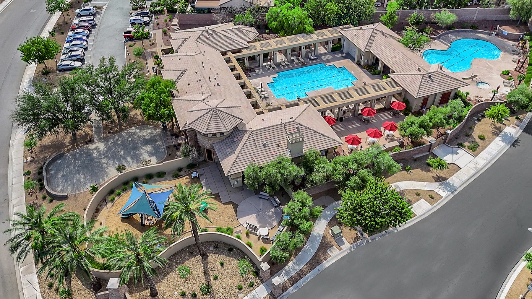Aerial view of the Southern Terrace clubhouse, showing both pools, a shaded playground, and lounge seating